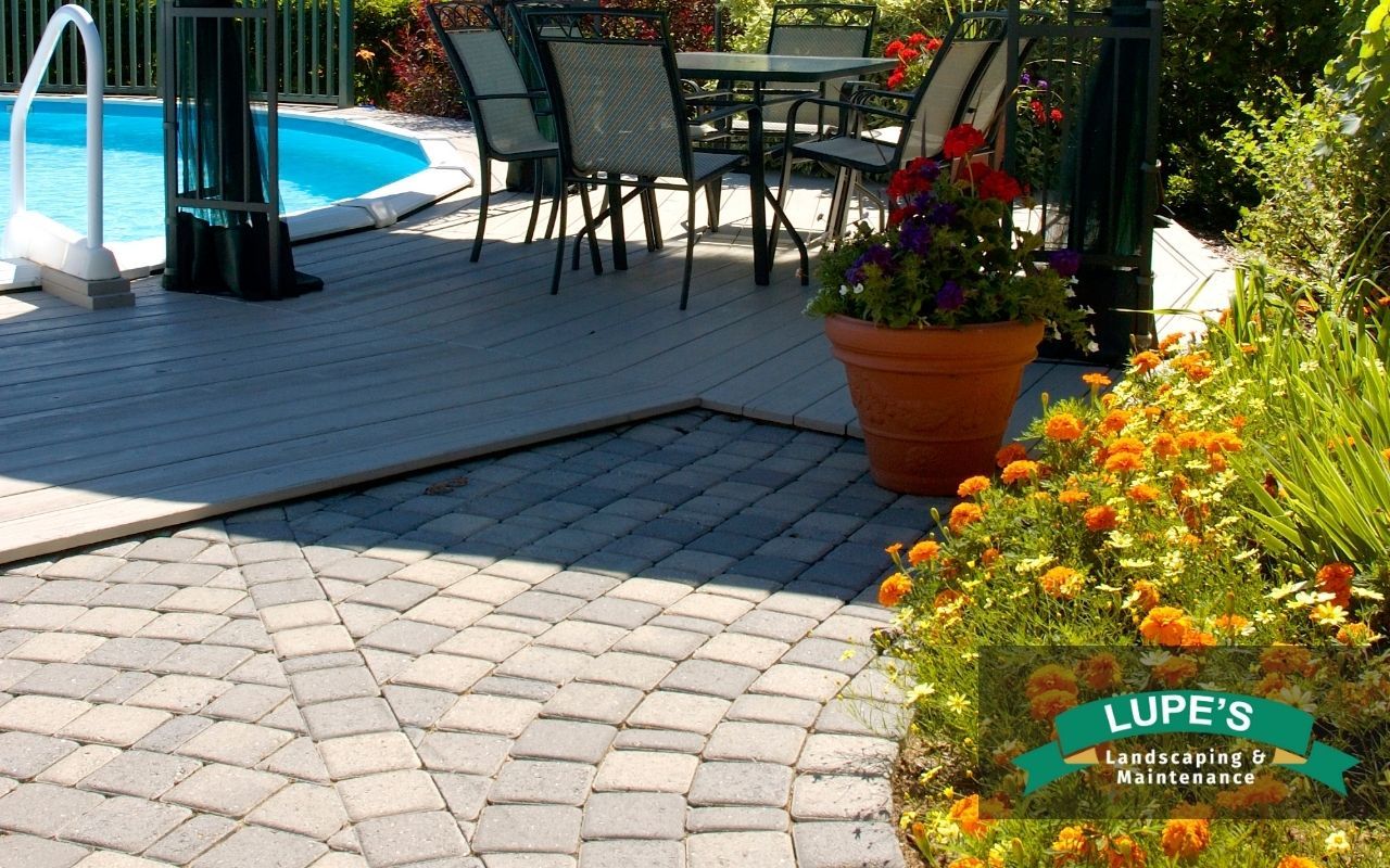 Backyard with stone pathways, native plants, and a permeable patio