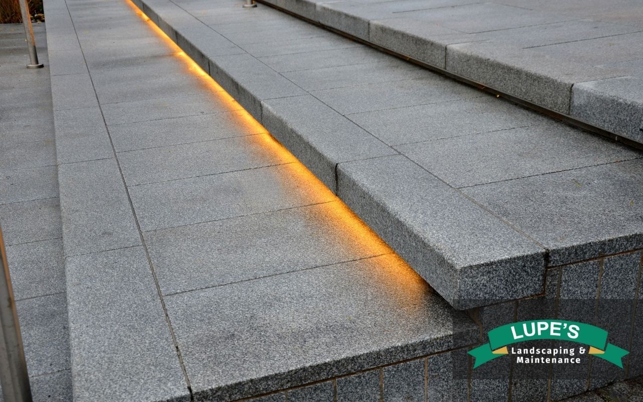 Recessed step lights illuminating stone stairs at night